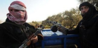 NATO Terrorism in Syria Two masked armed men holding rifles
