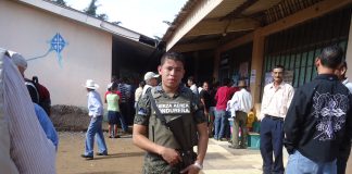 Canada has blood on its hands in Honduras A soldier in uniform holding a rifle among civilians outdoors.