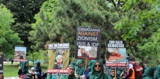 Perceptions vs Reality. Canada’s Stance on Islamophobia and Racism Protesters hold signs against Zionism, ISIS, and apartheid at a rally.