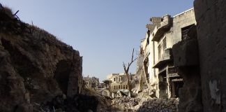 When the LIE is accepted as the Truth Ruined buildings and rubble under a clear sky in a war-torn area.