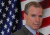 “The Salvador Option For Syria”: US-NATO Sponsored Death Squads Integrate “Opposition Forces”/ By Prof Michel Chossudovsky Man in suit with American flag background.