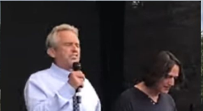 Season 2, Episode 1 of “TRUTH” with Robert F. Kennedy, Jr. Two men speaking at an event, one holding a microphone.