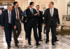 RUSSIA BREAKS THE US “CAESAR ACT” AND SYRIA REFUSES THE LEBANESE & IRAQI MODELS/ By Elijah J Magnier Leaders walking and conversing in an elegant hallway.