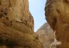 Maaloula, 2016 A narrow canyon with steep rock walls under a clear blue sky.