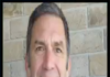 US ‘stealing, plundering’ Syrian oil: Analyst Smiling man in a blue shirt against a brick wall.