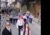 Damascus, Palm Sunday Celebrations A crowd of people walking down a street during a parade or event.