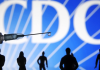 CDC: 3,005 Recorded Deaths in VAERS Following COVID-19 Experimental “Vaccines” – More than Total Vaccine Deaths for Past 13+ Years A drop of liquid on a needle with silhouetted figures in the background.