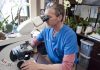 Medical Doctor and Director of Diagnostics Laboratory Presents Cures for COVID and Exposes Dangers of COVID “Vaccines” Scientist examining samples through a microscope in a lab.