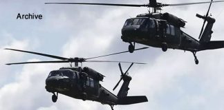 US occupation transfers 60 Daesh terrorists from QSD militia’s prisons in Hasaka to al-Omar oil field/ SANA Two military helicopters flying close with rotors spinning.