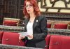 Syrian MP clarifies the goal of inviting parliaments to attend the 2021 presidential elections in Syria/ By Basma Qaddour A woman speaking in a formal assembly or parliament.