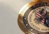 Video: Pfizer’s Criminal Record. Largest Medical “Fraudulent Marketing” Case in US History Close-up of a presidential seal with gold and red details.