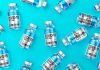 Teens 50X More Likely to Have Heart Disease after COVID Shots than All Other FDA Approved Vaccines in 2021 Combined – CDC Admits True but Still Recommends It Multiple COVID-19 vaccine vials on turquoise background
