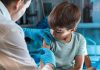 Stop the Covid Holocaust! Open Letter A child receiving a vaccination from a healthcare professional.