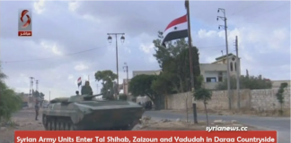 Syrian Arab Army is Ending the Terrorists Presence in Daraa Countryside\ By Arabi Souri A large Syrian flag flies high above a cityscape on a cloudy day.