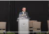 Drs. Ryan Cole and Robert Malone on vaccinating children Man speaking at a podium during a conference or event.