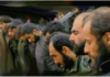 Eighth Anniversary of the Death of Legendary Martyrs of Al-Kindi Hospital/ By Prof. Anderson Men with bowed heads in a solemn gathering.