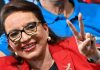 Hondurans Repudiate Corrupt U.S.-Backed Coup Regime at Polls/ By Jeremy Kuzmarov A smiling woman with glasses making a peace sign gesture.