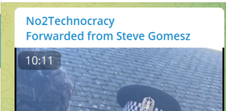 Activist Reports COVID Crimes to Police A police officer wearing a mask talks to a man outside a building.