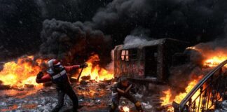The US Is the Major Instigator of the Ukraine Conflict. The Historical Facts/By Rick Sterling Firefighters battling intense flames amid heavy smoke and wreckage.