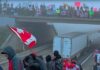 Video: Justin Trudeau Accuses Freedom Convoy 2022 of Propagating Hatred, Racism and Violence/ By Prof Chossudovsky Protesters gather under a bridge holding Canadian flags and signs.