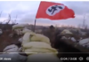 Ukrainian soldiers defending a trench with the Nazi flag waving/ Twitter by Katu Arkonada