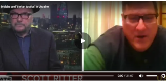Scott Ritter on biolabs and “Syrian tactics” in Ukraine A news anchor and a guest in a split-screen video call during a broadcast.