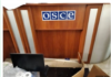 OSCE Corruption/ via Eva K Bartlett Damaged area inside an office with an OSCE sign on the wall.