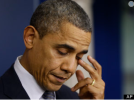 A man in deep thought touching his face.