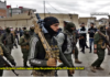 ISIS Remnants Assassinate another Baath Party Official in Daraa/ By Arabi Souri Masked militants holding rifles in a street setting.