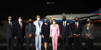 Winds of War in Eurasia/ By Manlio Dinucci Leaders wearing masks stand in front of an airplane at night.