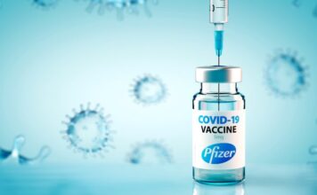 Australian COVID-19 pandemic: A Bradford Hill analysis of iatrogenic excess mortality February 2023/ By Wilson Sy A Pfizer COVID-19 vaccine vial with a syringe drawing the vaccine.