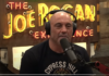 Rogan on Psychological Warfare and Jab Coercion A man speaking into a microphone on a podcast set.
