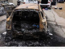 A car completely burnt out, showing severe fire damage.