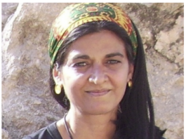 Portrait of a woman outdoors with a colorful headscarf.