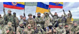 Group of soldiers in camouflage holding flags and posing.