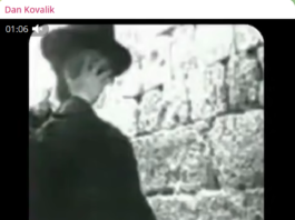 A vintage black-and-white image of a Jewish man praying at the Western Wall.