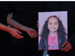 Hands holding portrait of smiling young girl