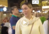 Iran Woman in yellow blouse at crowded night market