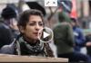 War Against Imperialism Woman at protest holding cardboard sign
