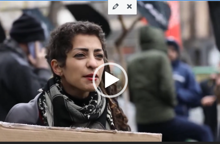Woman at protest holding cardboard sign