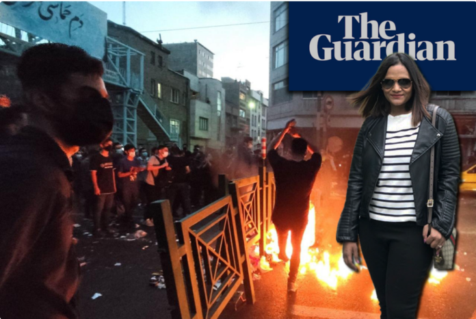 Woman in sunglasses beside fiery street protest