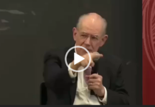 Evil Empire/ Prof. John Mearsheimer Bald man in suit pointing during discussion