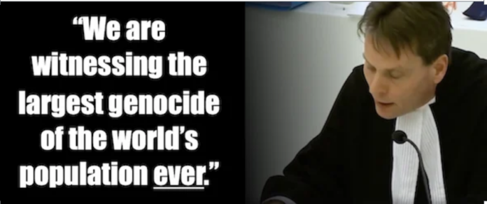 Man in robe beside large genocide quote