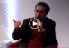 L’Iran Des Mollahs Uniquement? Seated speaker gesturing while holding microphone