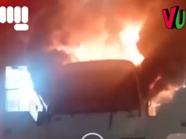 Car engulfed in intense flames inside structure