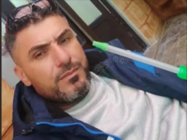 Bearded man in blue jacket with mop